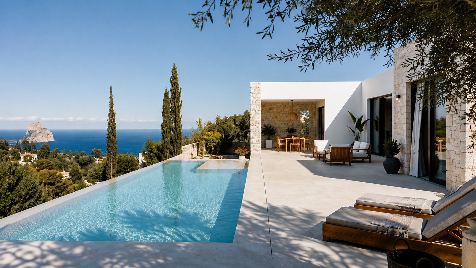 Clifftop Mediterranean villa terrace with infinity pool, olive trees and the Costa Blanca coastline.